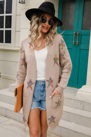 Dust Storm knit cardigan with colorful embroidered starbursts, open front, long sleeves, and pockets.