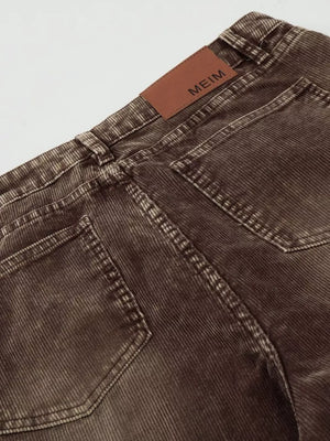 Brown corduroy joggers for men, showing back pockets and leather logo patch.