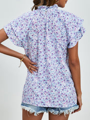 Light blue floral blouse with ruffled neckline and flutter sleeves