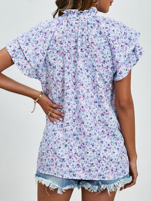 Light blue floral blouse with ruffled neckline and flutter sleeves