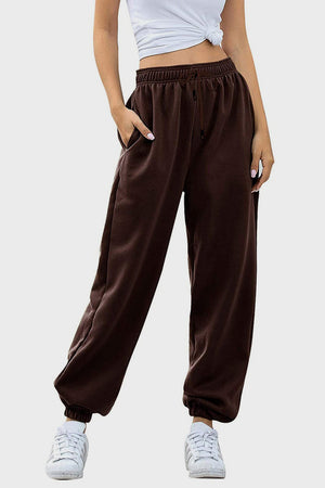 Relaxed-fit cuffed sweatpants in chocolate brown with drawstring waist and pockets.