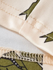 Toddler dinosaur print tee and shorts set in cream with green dinosaur pattern and stitched details.