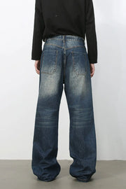 Medium wash distressed wide-leg jeans with a relaxed fit and visible back pockets.