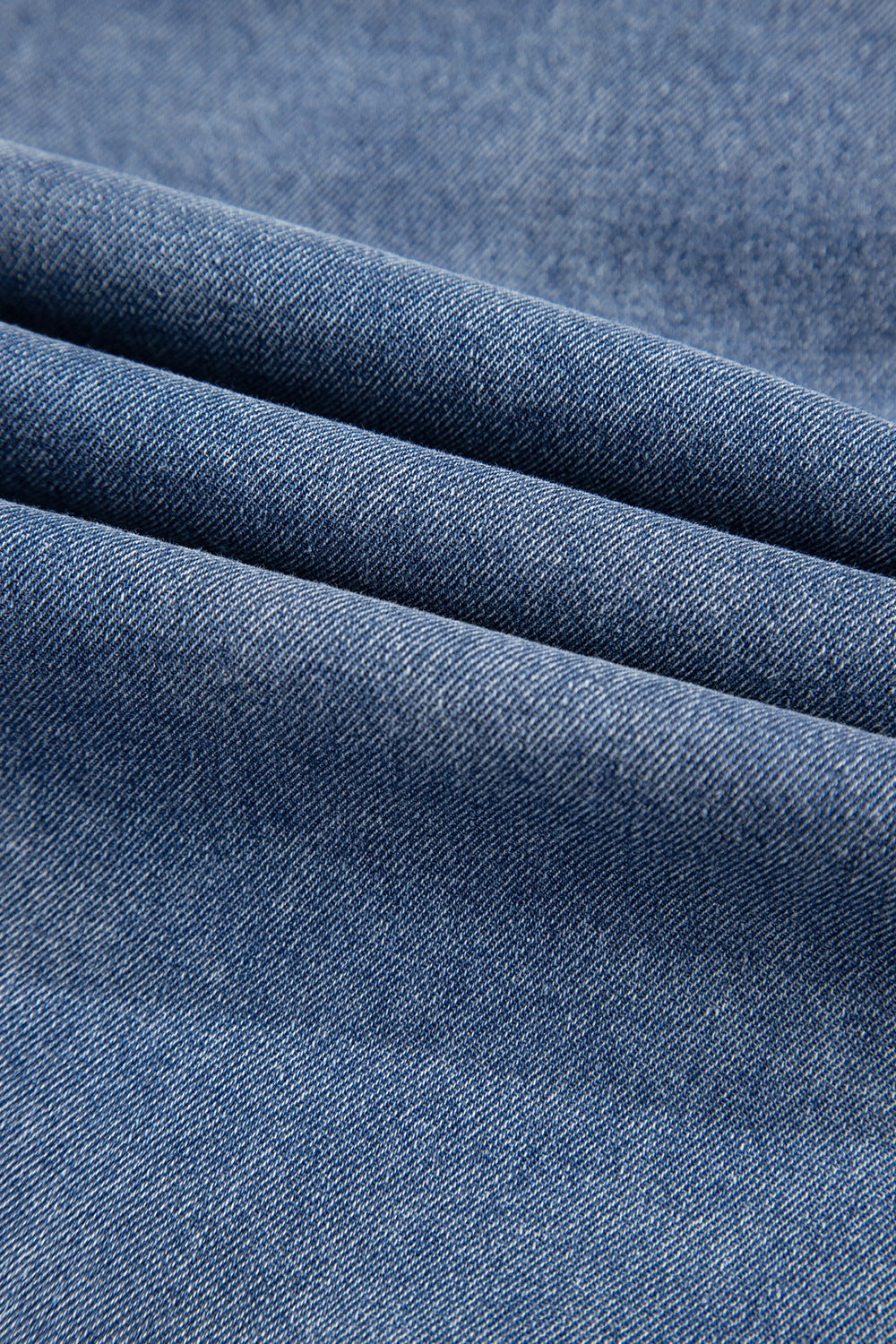 Denim ruffle collar mini dress in medium blue wash, showing fabric texture.