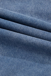Denim ruffle collar mini dress in medium blue wash, showing fabric texture.