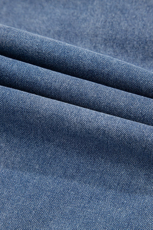 Denim ruffle collar mini dress in medium blue wash, showing fabric texture.