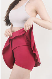 Sculpted flared skort in red with built-in shorts, showing breathable activewear fabric.