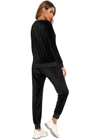 Black velvet lounge set with contrast trim, long sleeve top and jogger pants.