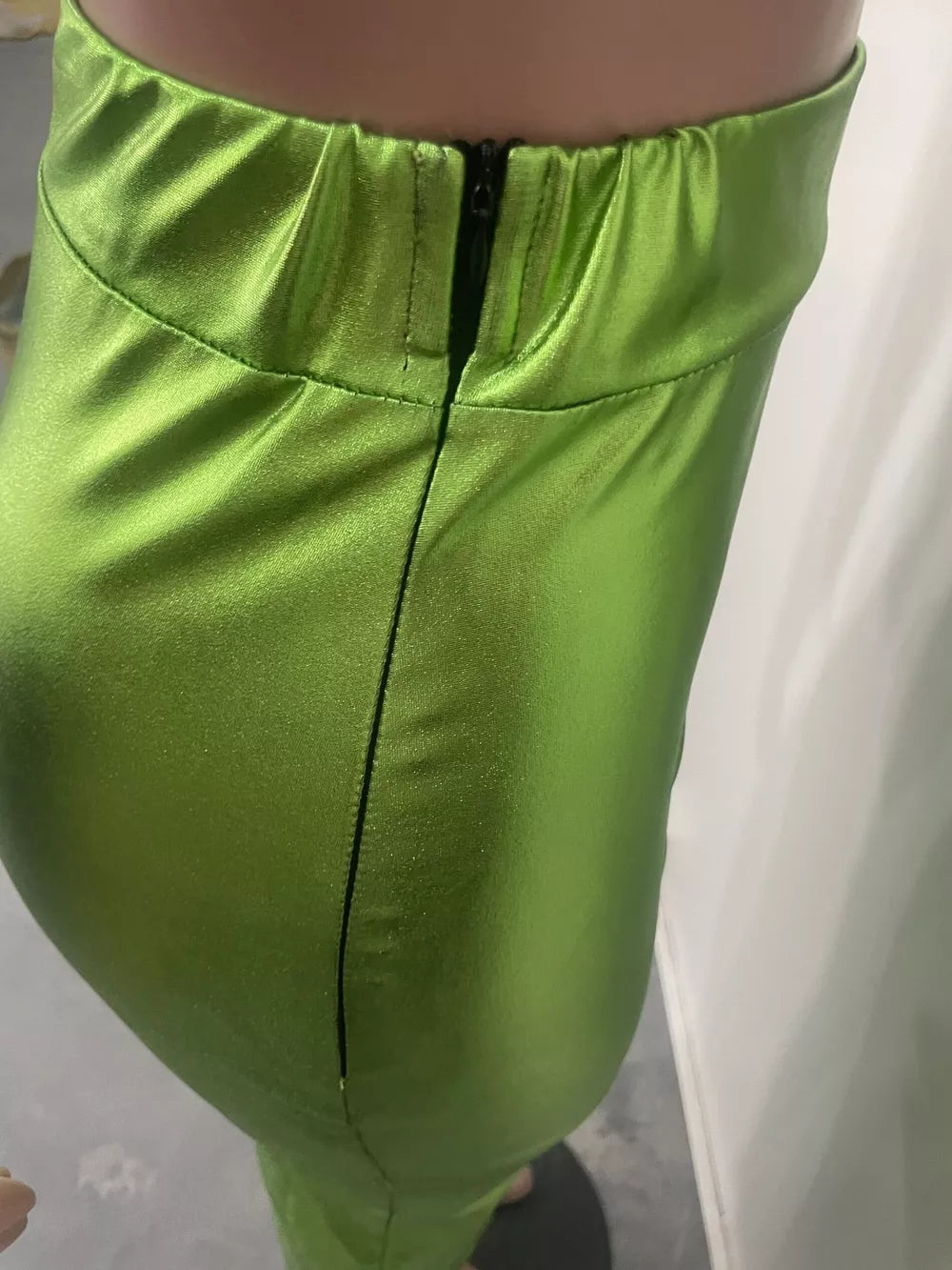 Glistening lime green high-waisted maxi skirt with a back zipper and bodycon fit.