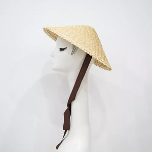 Chic conical wheat straw sun hat with scalloped brim and brown ribbon tie.