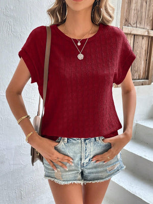 Burgundy woven texture cap-sleeve blouse with a crew neck.