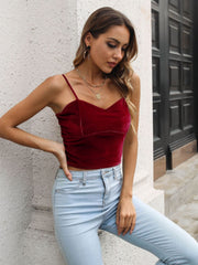Burgundy velvet bustier crop top with spaghetti straps and sweetheart neckline.