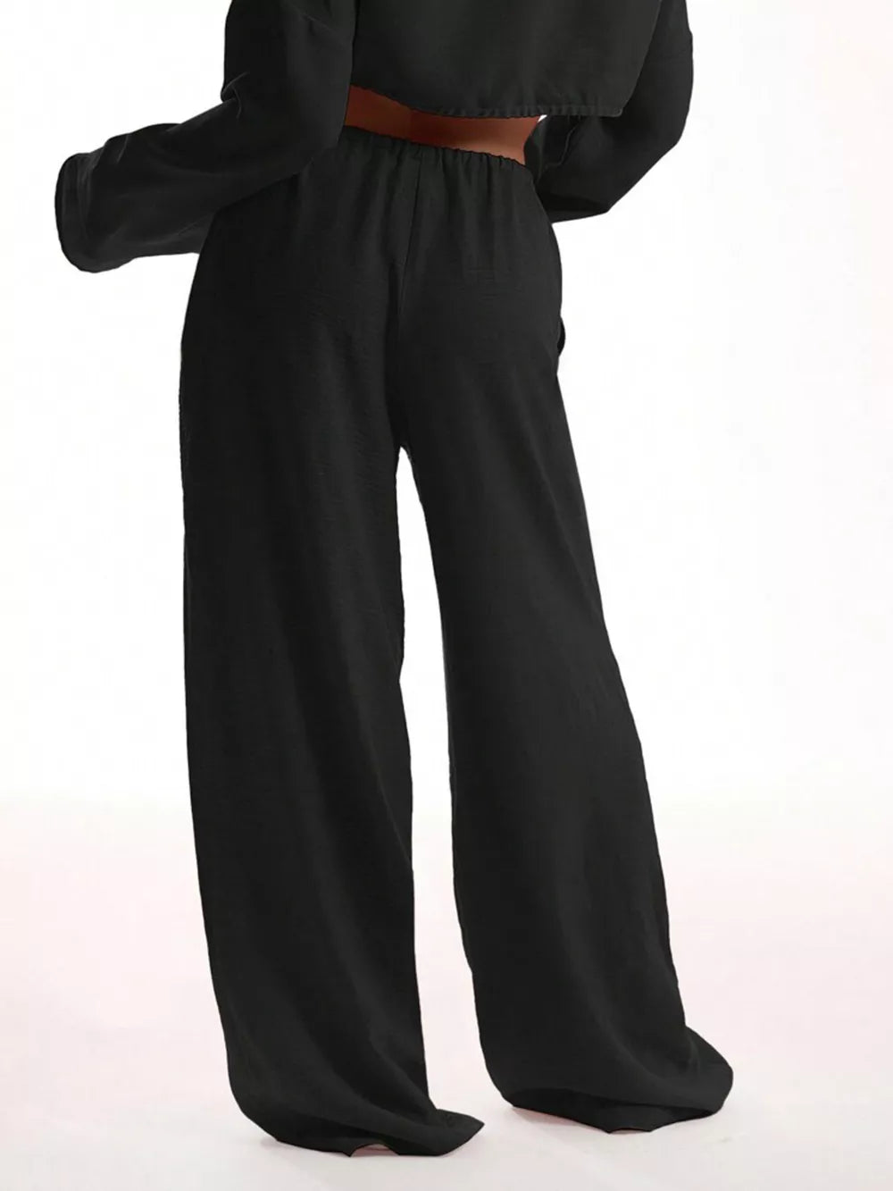 Black maternity pants with a relaxed wide-leg cut and elastic waistband.