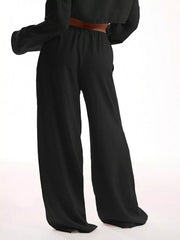 Black maternity pants with a relaxed wide-leg cut and elastic waistband.