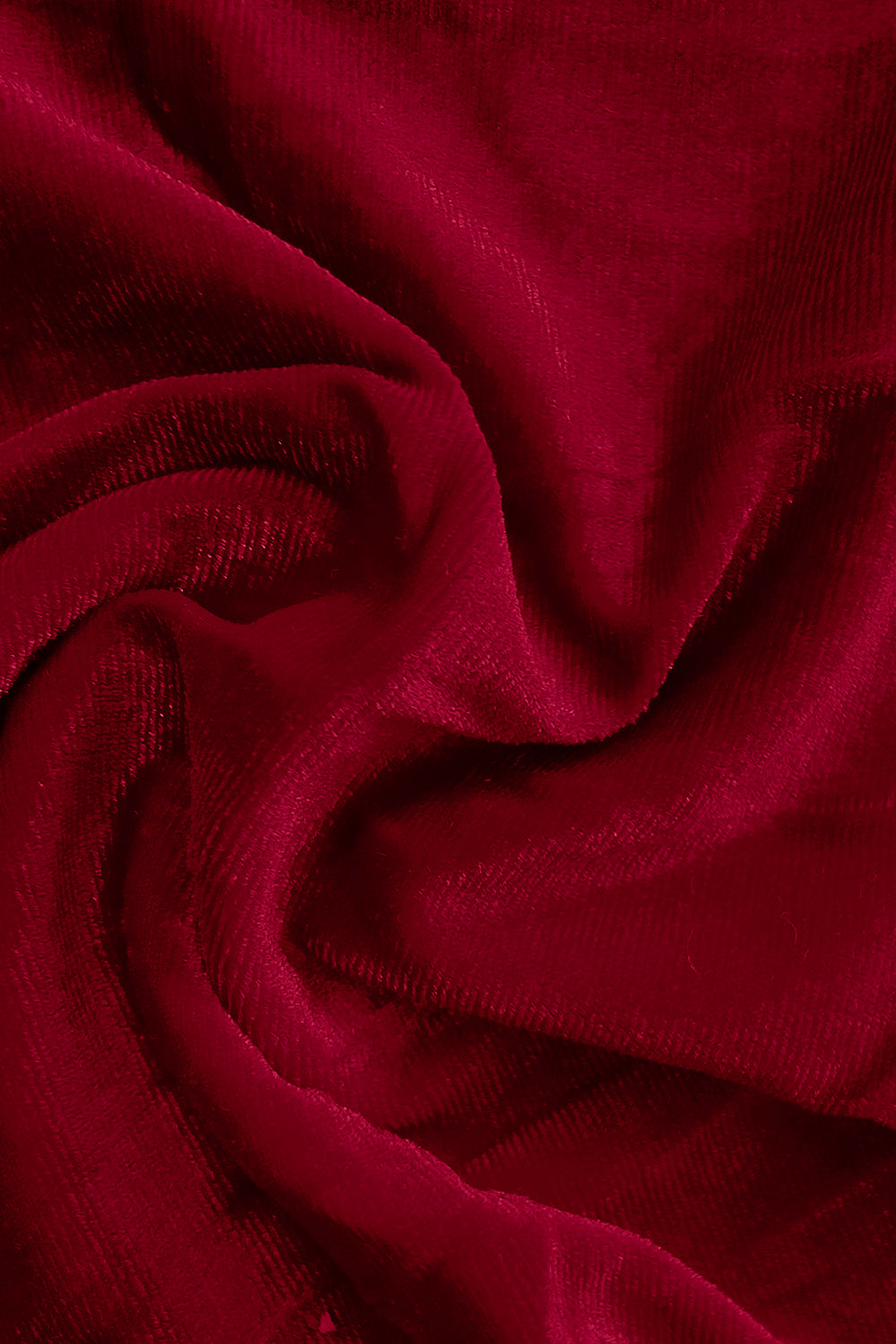 Plush velvet wide-leg trousers in burgundy, showing fabric texture and drape.