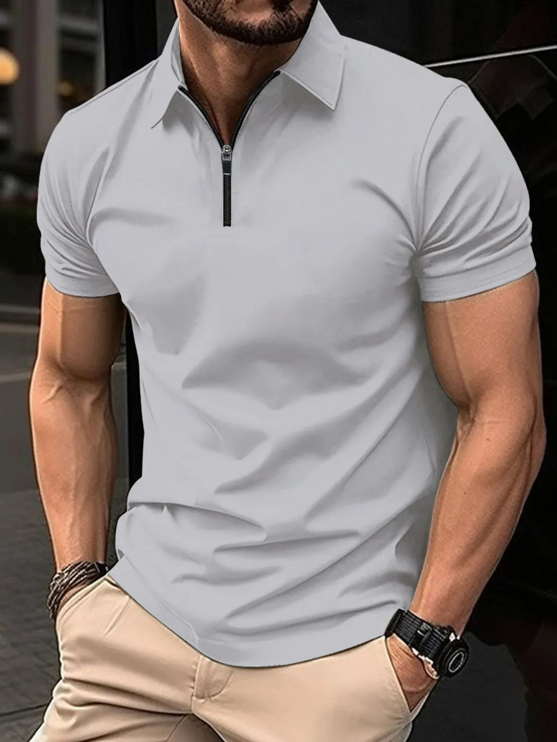 Gray zip-neck polo shirt with short sleeves and a modern fit.