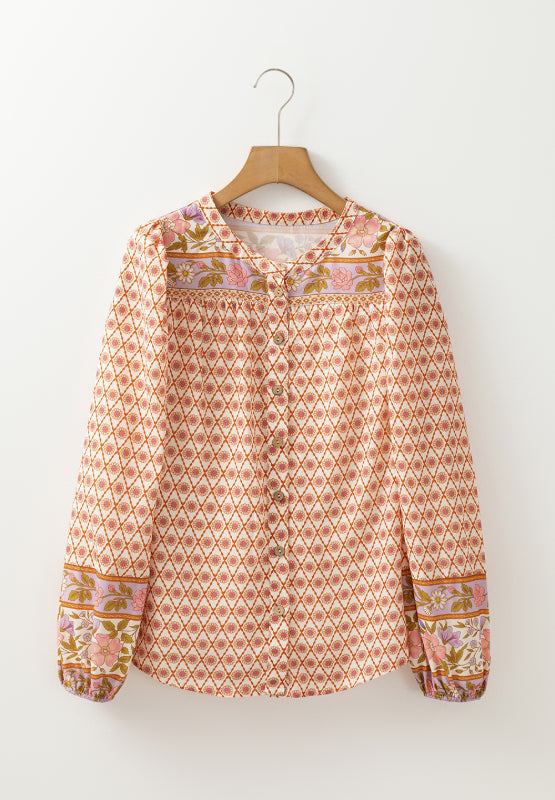 Bohemian print blouson sleeve top with button front and floral cuffs.