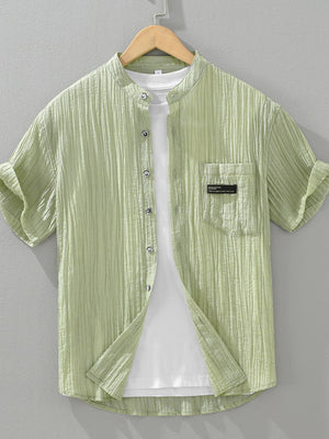 Light green textured button-up shirt with mandarin collar and chest pocket, short sleeves.