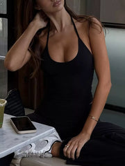 Black halter crop top and wide-leg pants set with a scoop neckline.