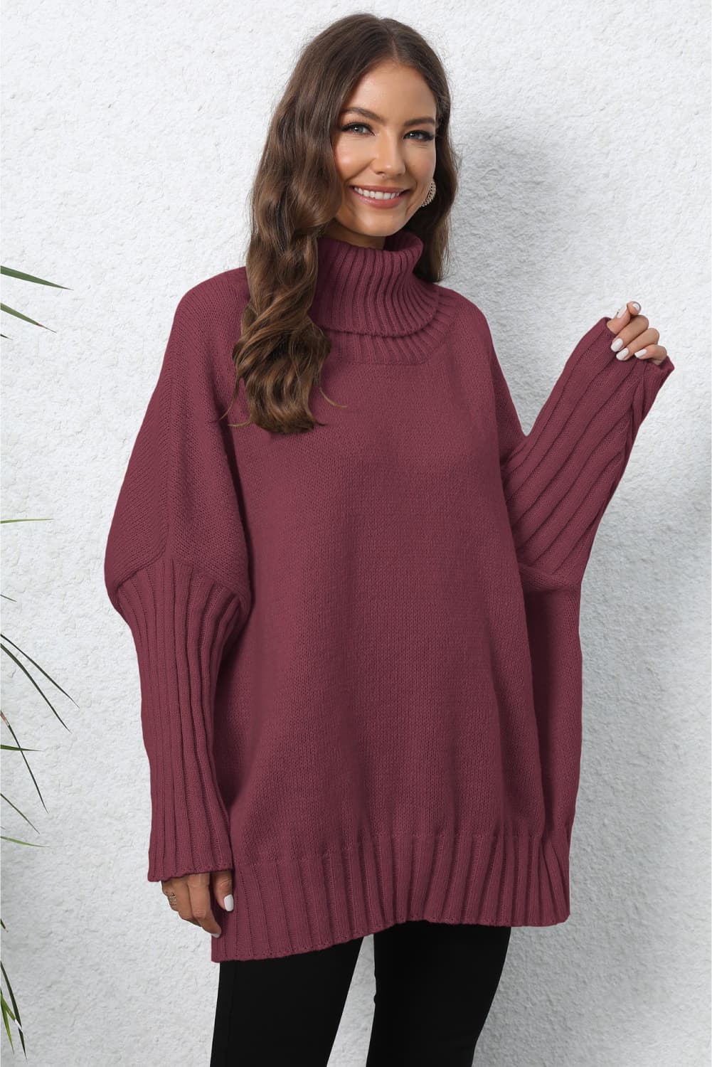 Burgundy ribbed turtleneck sweater with batwing sleeves and ribbed cuffs.