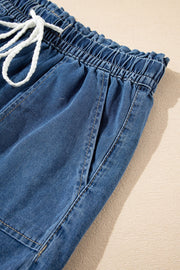 Navy denim drawstring shorts with elastic waist and white tie.