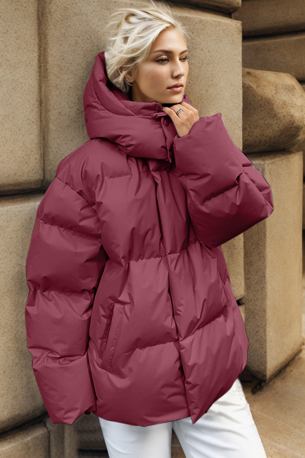 Burgundy oversized puffer jacket with hood and pockets, casual winter outerwear.
