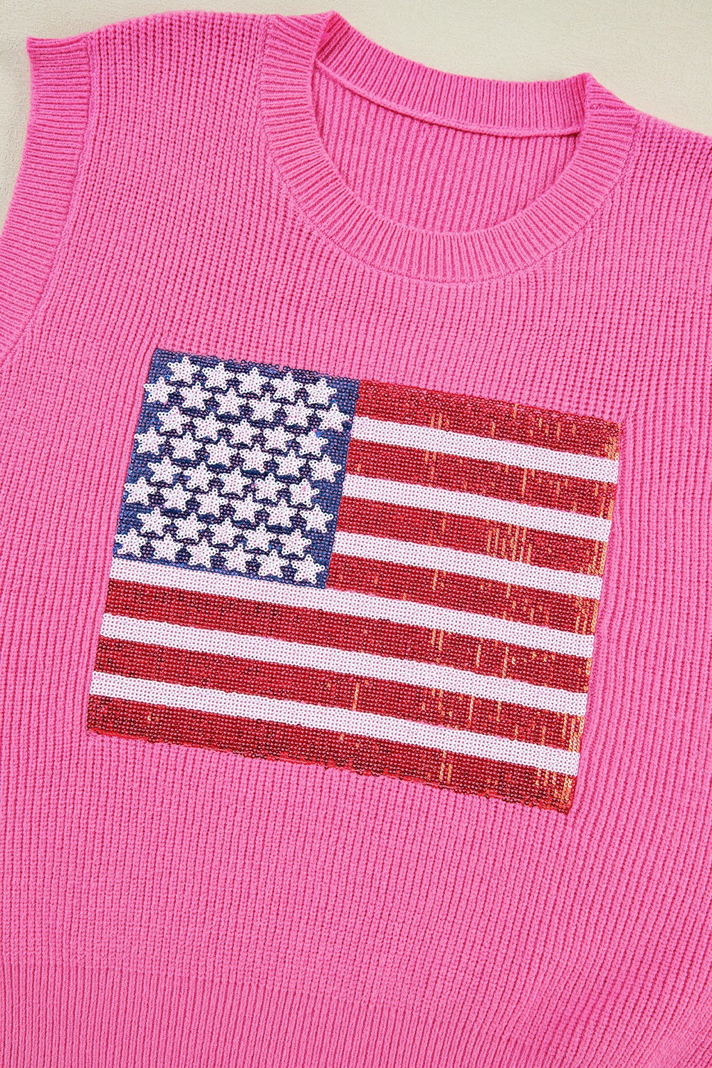 Fuchsia pink knit tank top with a sequin American flag detail on the chest.