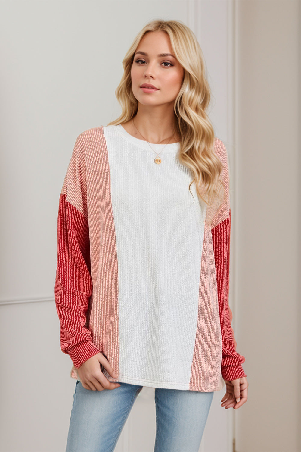 Colorblock waffle knit pullover sweater with white, coral, and red panels.