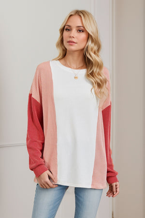 Colorblock waffle knit pullover sweater with white, coral, and red panels.