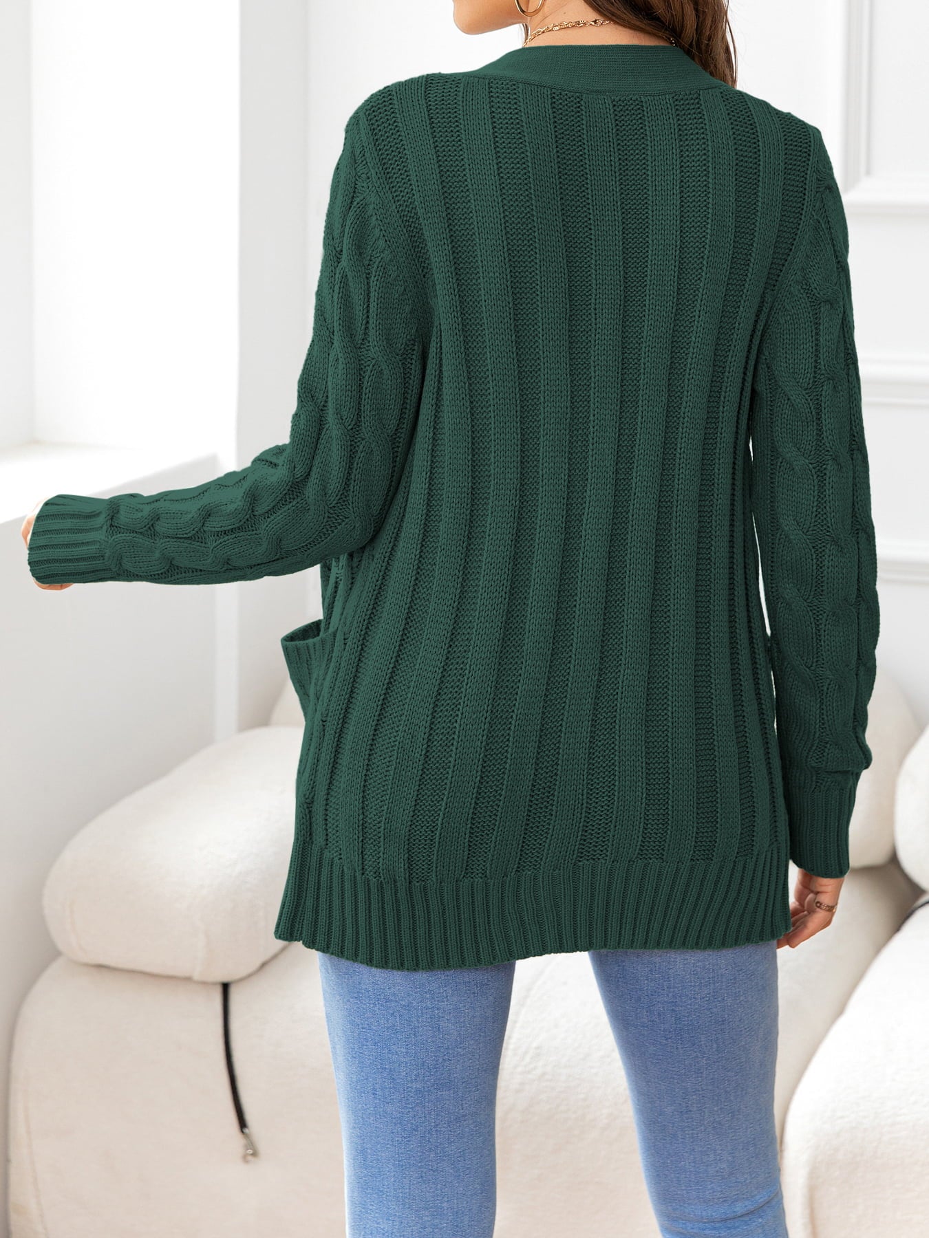 Textured cable-knit pocket cardigan in Gum Leaf green acrylic with ribbed details and pockets.