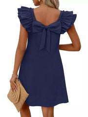 Navy blue a-line dress with ruffled cap sleeves and a large bow detail on the back.