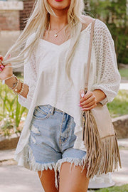 White lace-inset dolman sleeve blouse with a v-neckline and flowy hem.