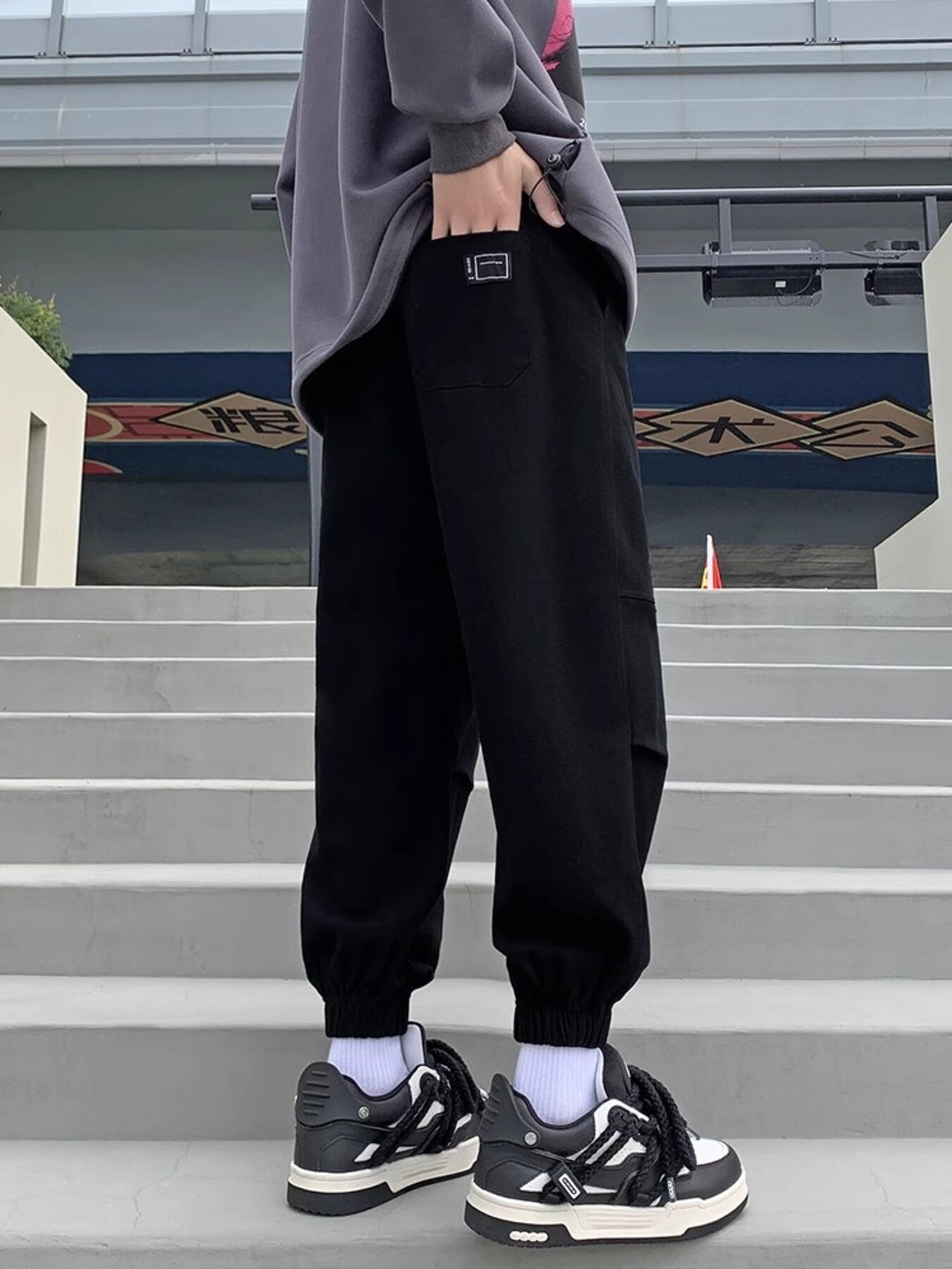 Black relaxed fit joggers with pockets and elastic cuffs.