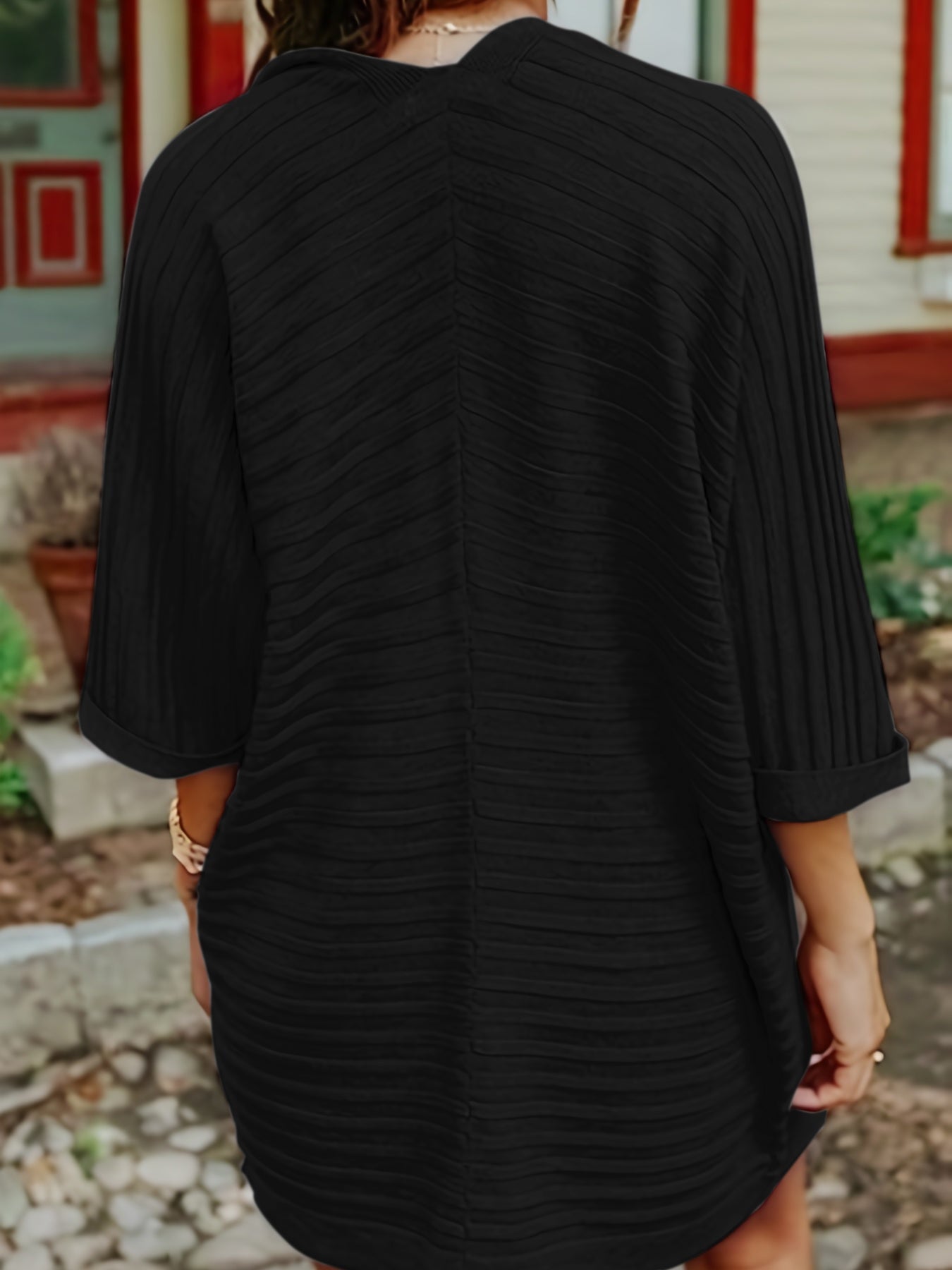 Black textured ribbed sleeve cardigan with a V-shaped seam detail on the back.