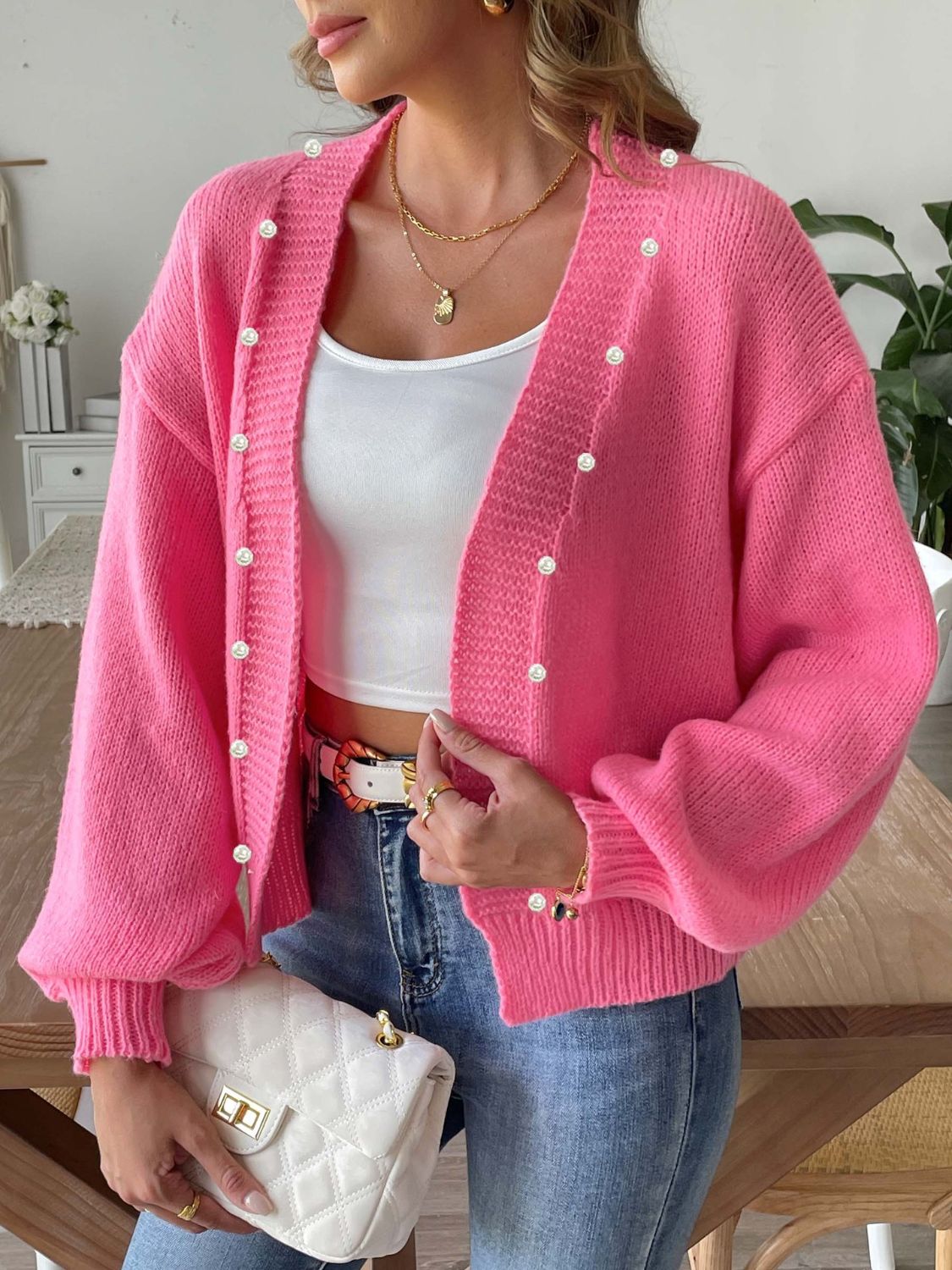 Bubble sleeve cardigan in fuchsia pink with pearl buttons and a relaxed fit.