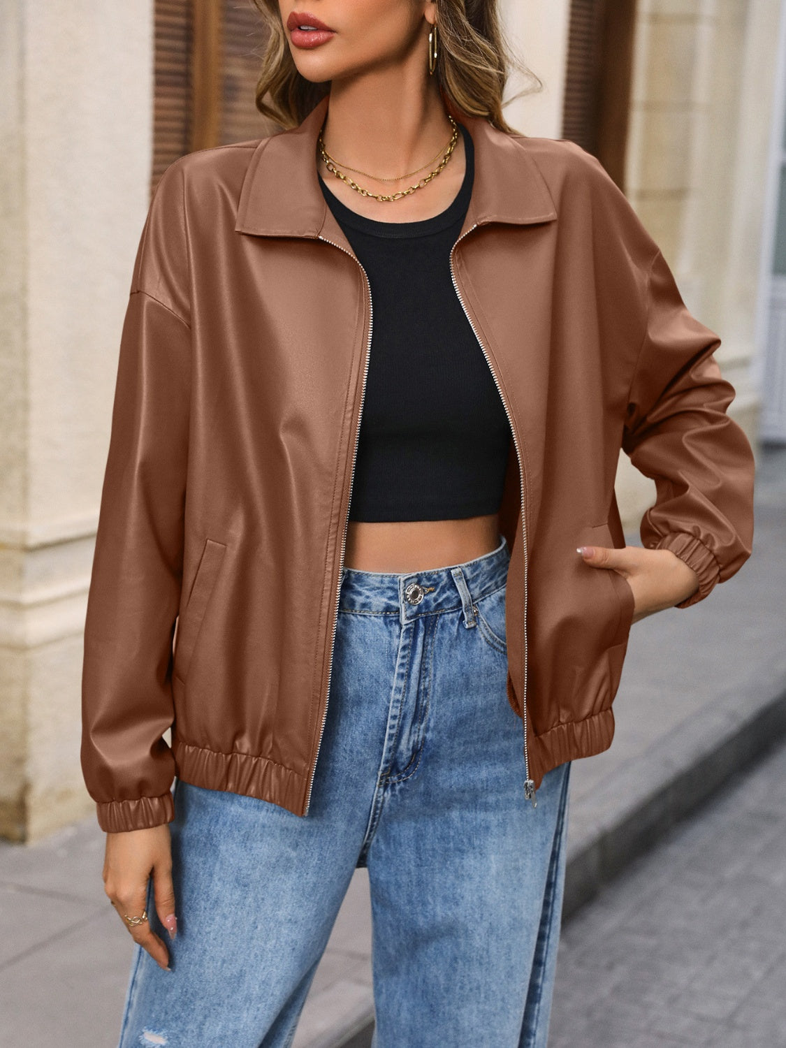 Brown faux leather bomber jacket with zip front and elastic cuffs