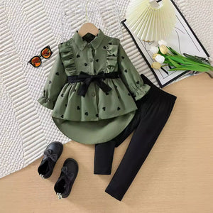 Toddler girls' green heart print ruffle button-down shirt with black bow belt and black leggings.