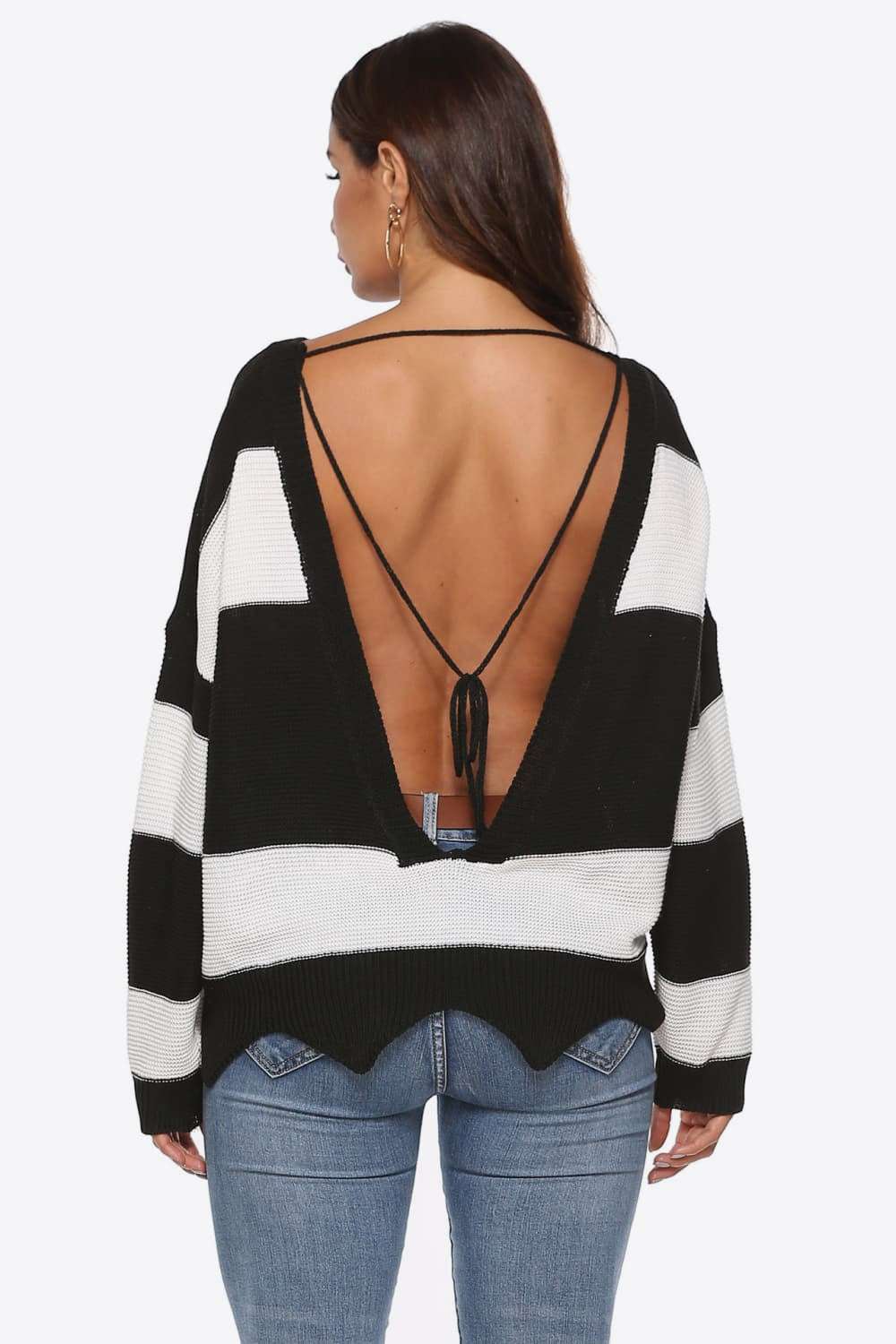 Open-back stripe knit sweater with frayed hem and tie detail.