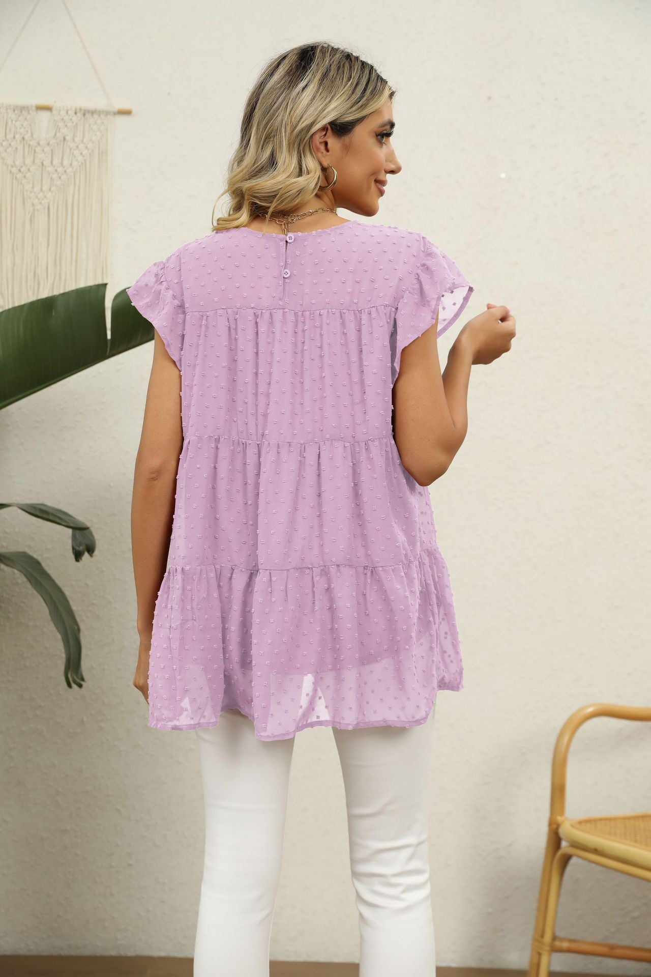 Pink lavender Swiss dot tiered blouse with flutter sleeves and button back detail.