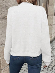 White geometric quilted bomber jacket with a mock neck and ribbed cuffs and hem.