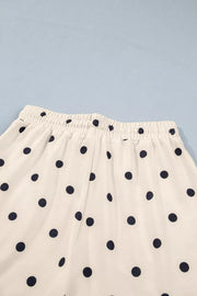 White polyester bikini bottoms with navy polka dots and elastic waistband.