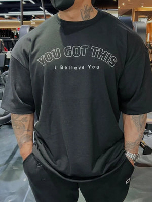 Black oversized tee with white "YOU GOT THIS I Believe You" graphic print.