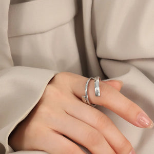 Silver sculptural spiral steel ring with a modern, minimalist design.