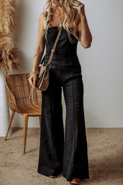 Black structured flare jumpsuit with plunging neckline and wide legs.