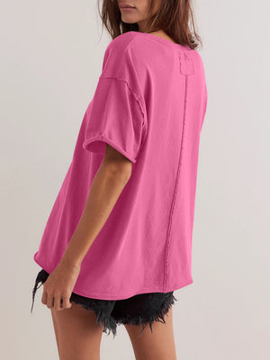 Oversized hot pink cotton tee with seam detail and raw edges.