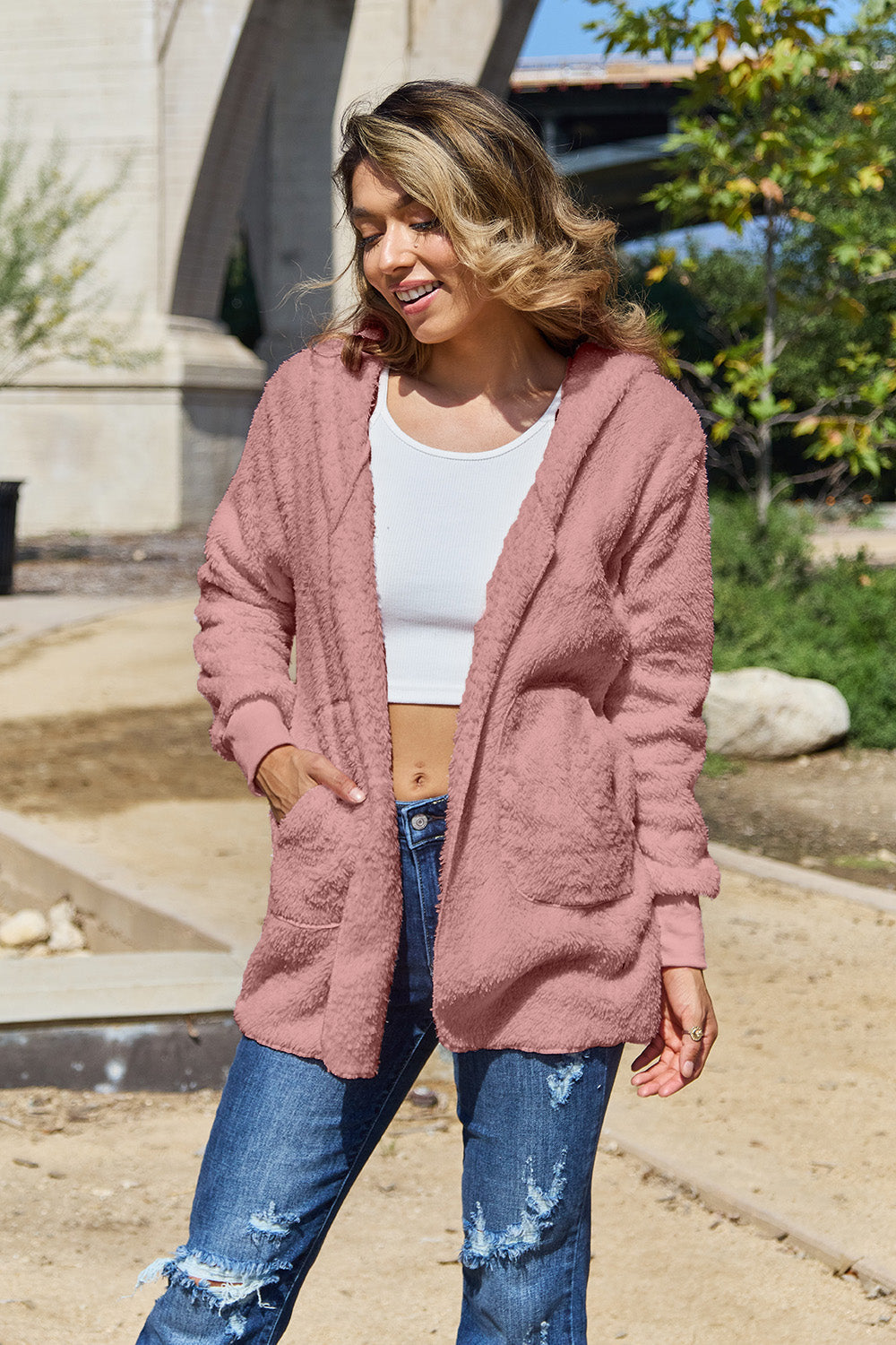 Plush hooded cardigan jacket in blush pink with open front and pockets.
