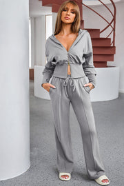 Dark gray cropped zip-up hoodie and wide leg lounge pants set with drawstring waist.