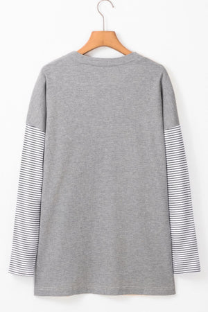 Light gray cardigan with contrasting striped sleeves.