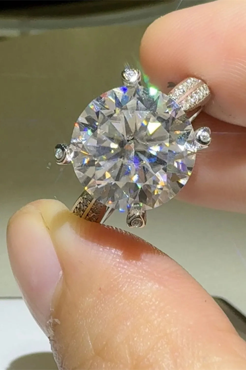 Silver round moissanite engagement ring with pavé band detail