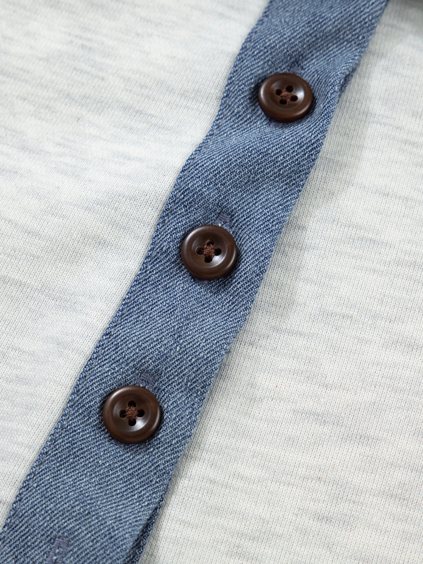 Light grey cotton casual top with denim placket and brown buttons.